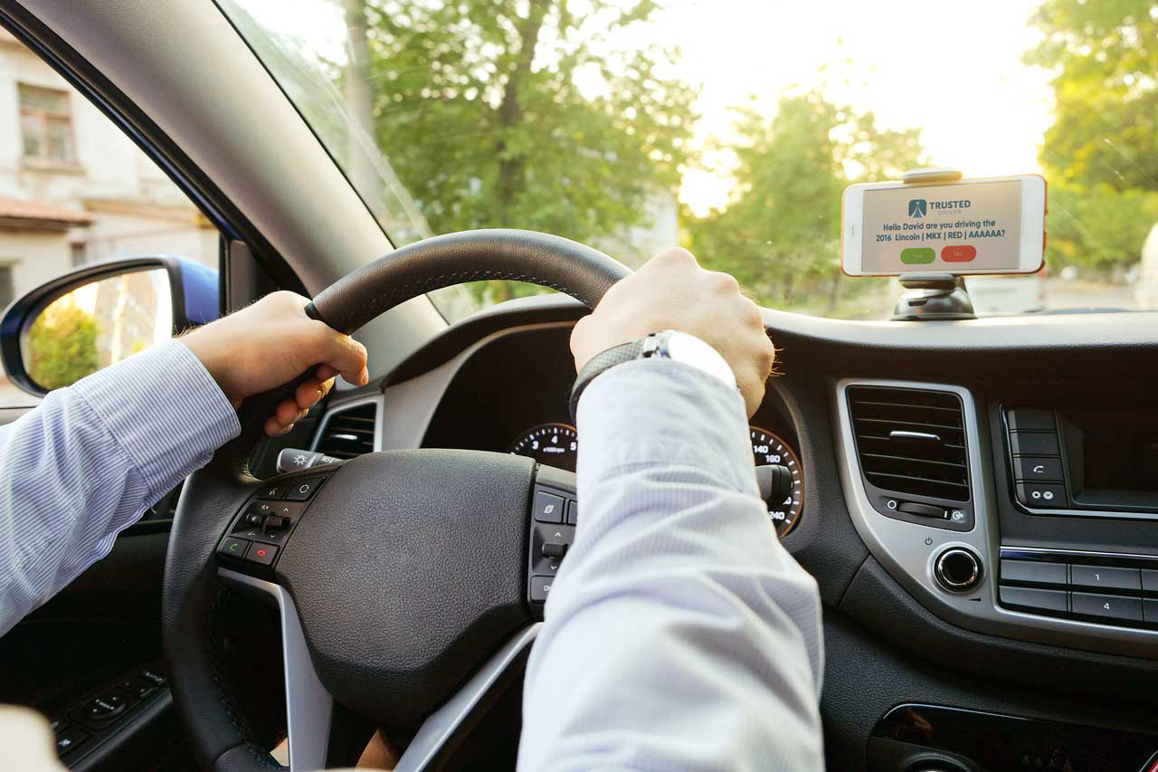 a Trusted Driver member checking his smartphone for updates