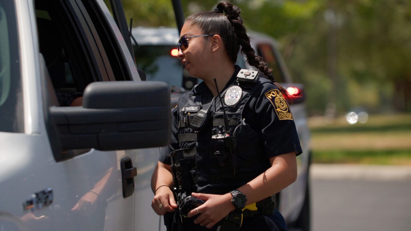 Officer speaks to driver during traffic stop. (Trusted Driver)