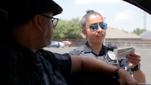 Officer speaks to driver during traffic stop. (Trusted Driver)